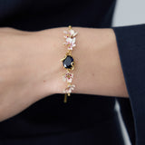Bracelet with Blue Faceted Stone, Gold Snake and Mallow Flowers