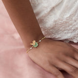 Bracelet with a Round Green Stone, Dragonfly, and Pink Hellebore